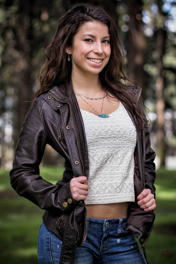 outdoor natural light portrait college student woman wearing leather and smiling