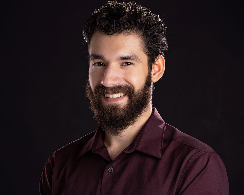man with beard smiling studio portrait