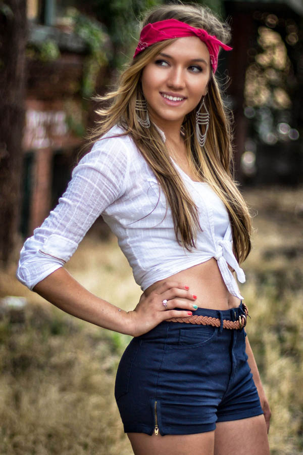 portrait of female college student wearing high waist shorts and bandana