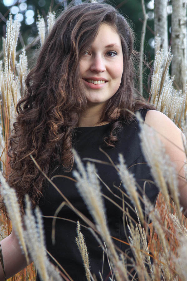 portrait girl next to soft plant in park