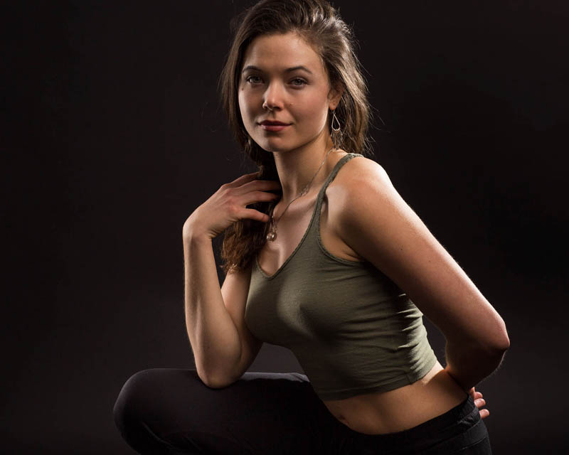 high school senior girl sitting on bridge