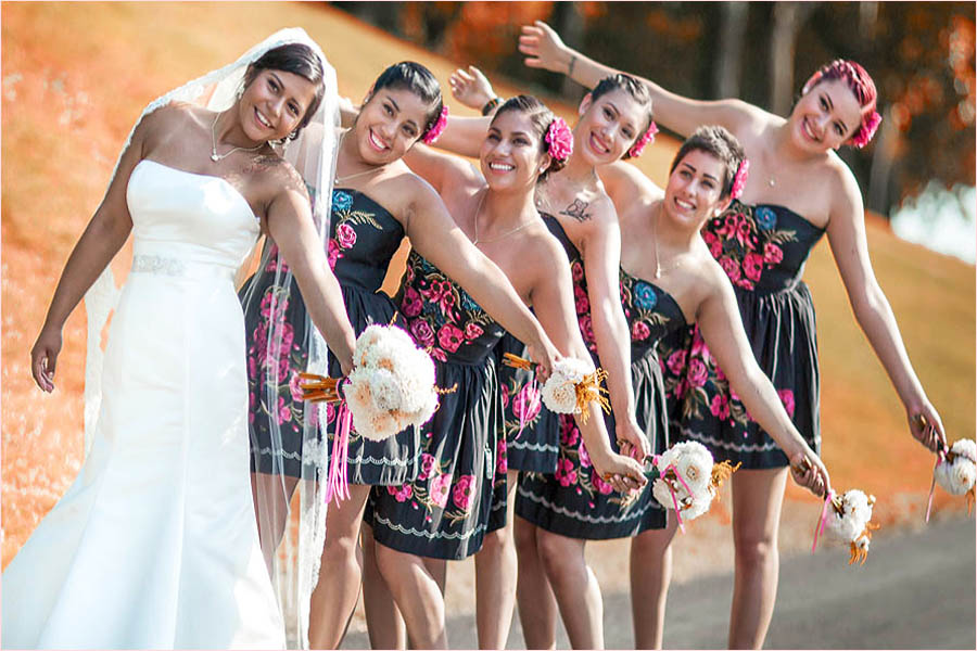 bridesmaids and bride laughing holding bouquets