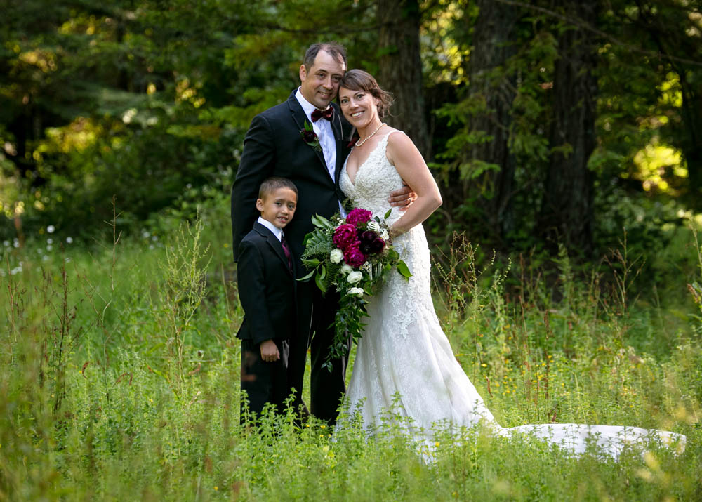 bride, groom and son at a ranch wedding